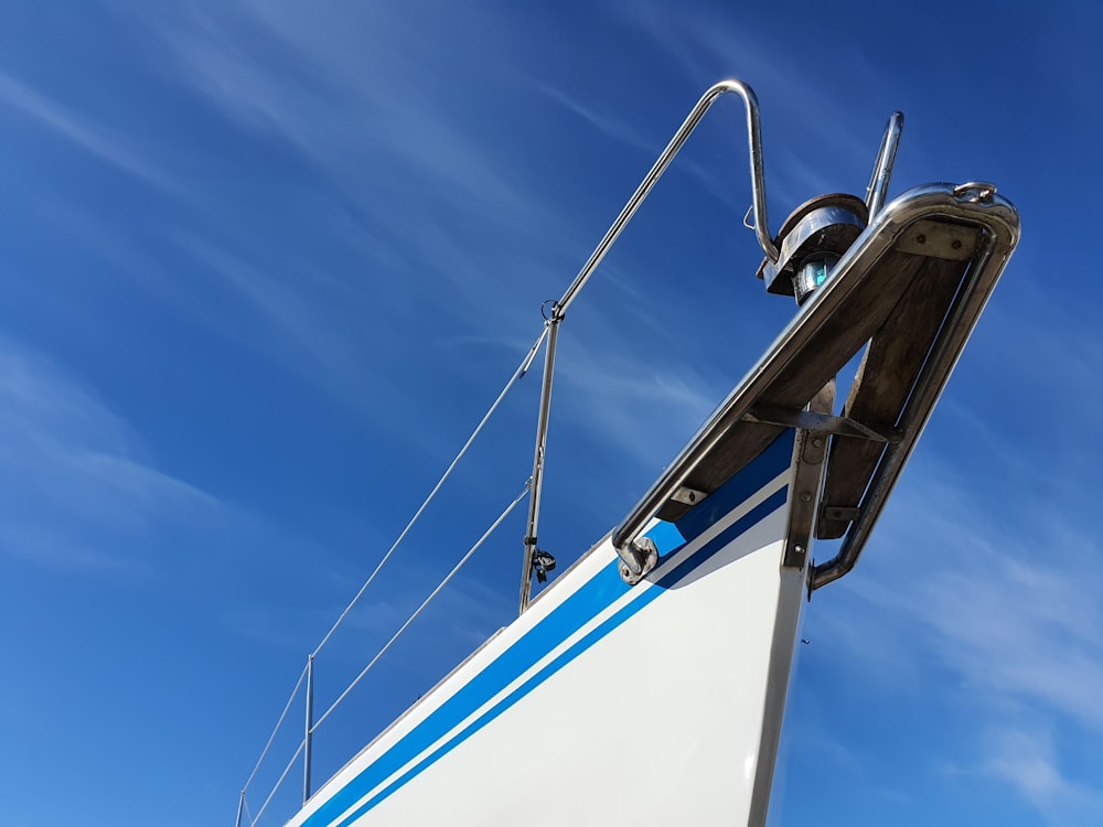 white and blue boat under blue sky during daytime