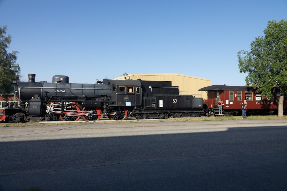black and red train on rail road during daytime