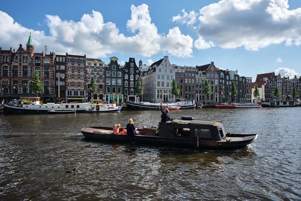 people riding on boat on river during daytime