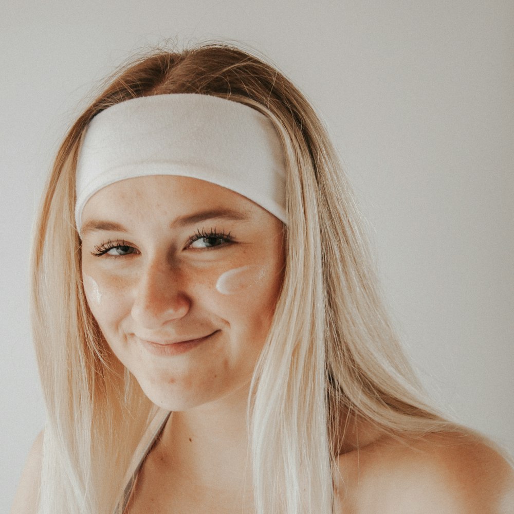 woman in white tank top smiling