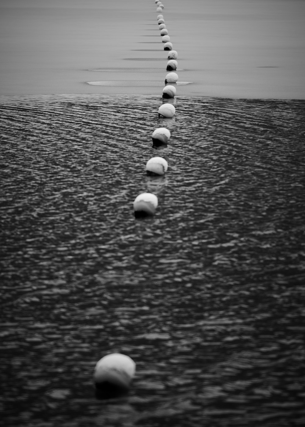 white round stones on black sand during daytime
