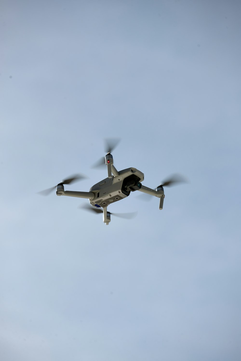 black and white drone flying in the sky