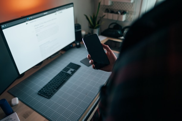 A vibrant workspace showing hands exchanging products and digital devices displaying online shops.