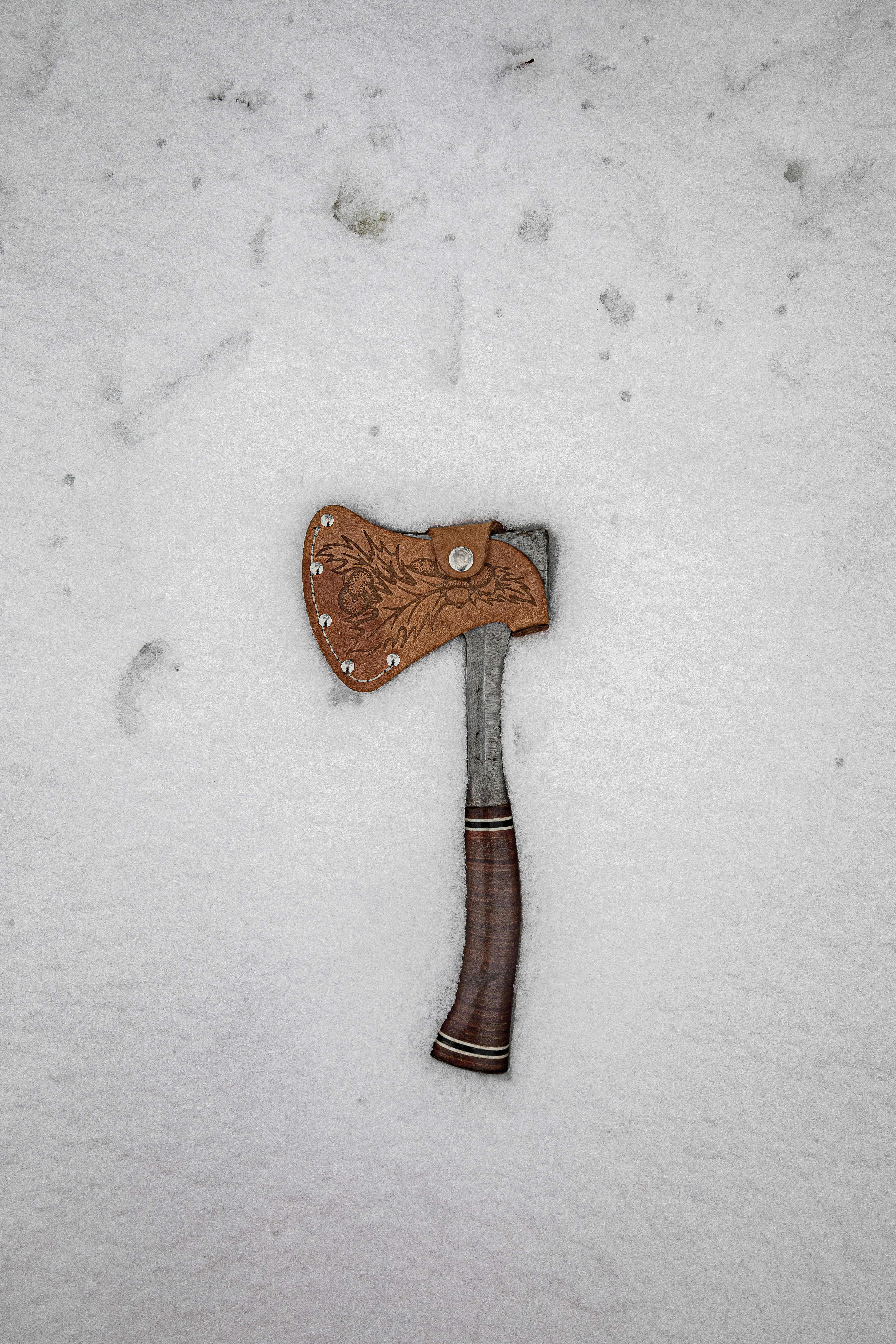 brown and silver knife on white textile