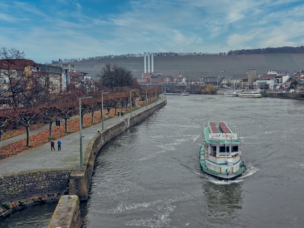 green and white boat on river during daytime