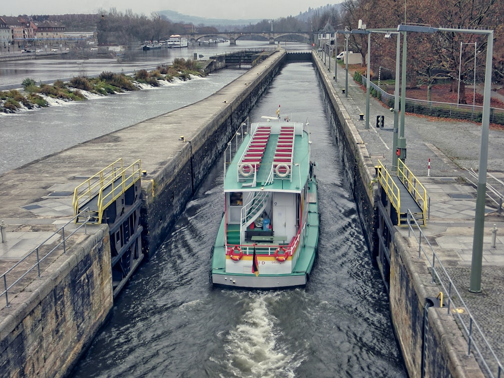 green and white boat on river during daytime