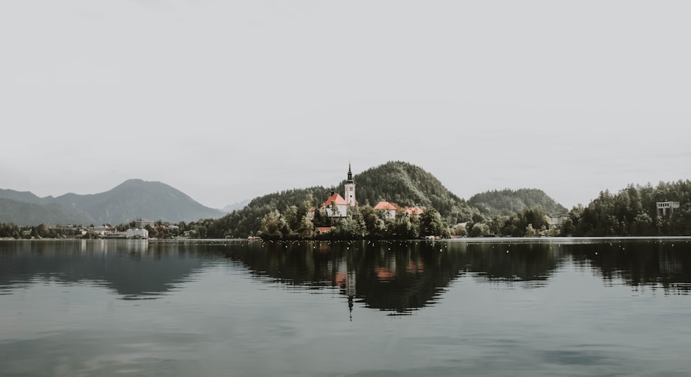 body of water near mountain during daytime