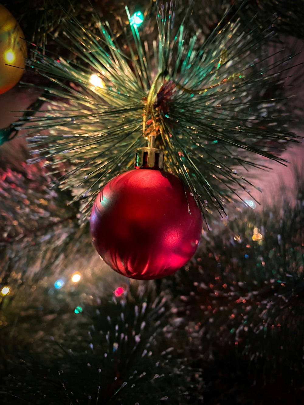 red and gold baubles on green christmas tree