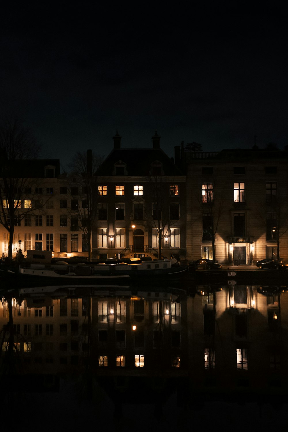 lighted building near body of water during night time