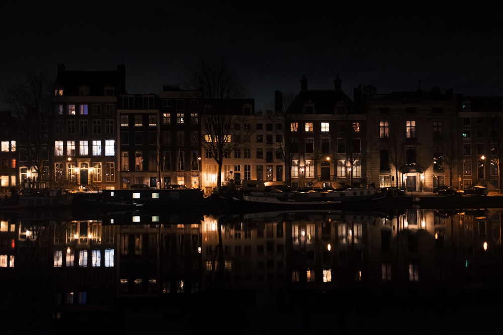 lighted building near body of water during night time