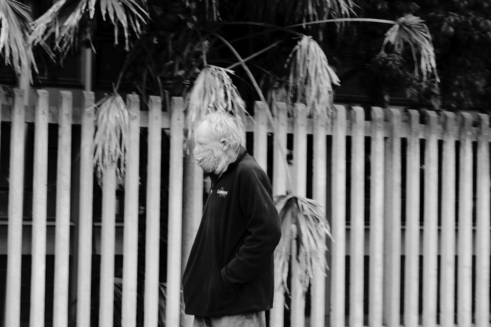 woman in black coat standing near fence