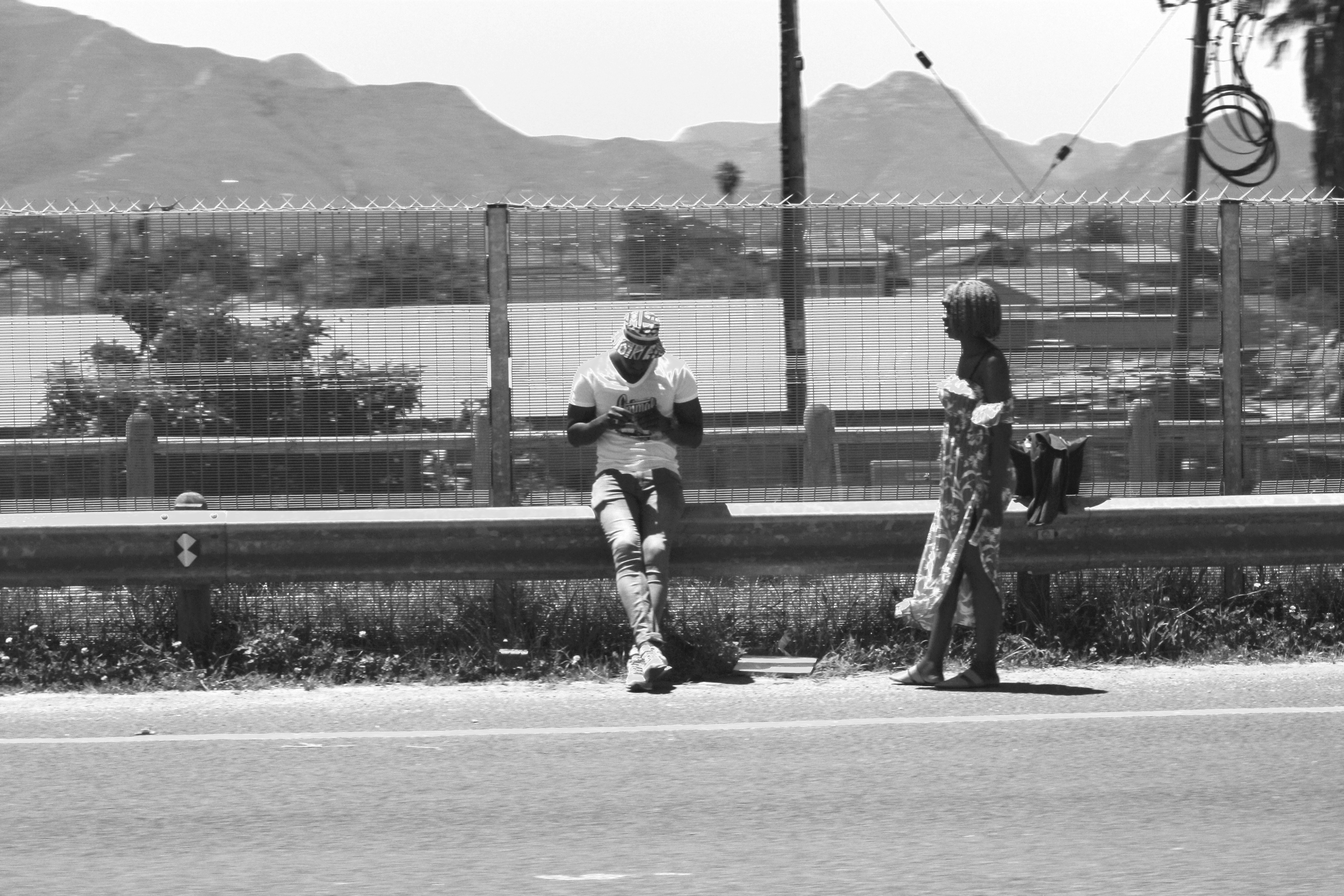 grayscale photo of 2 women standing on field
