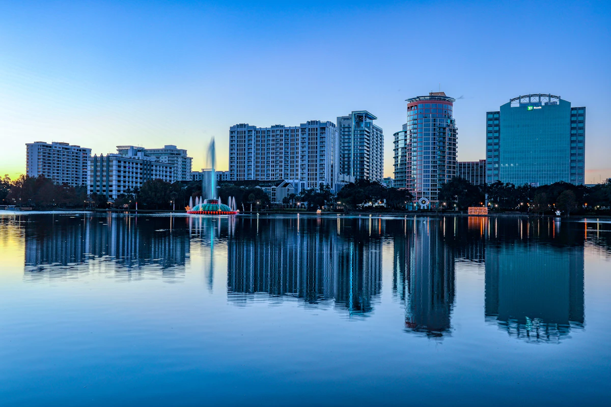Downtown Orlando skyline reflected across Lake Eola at dusk