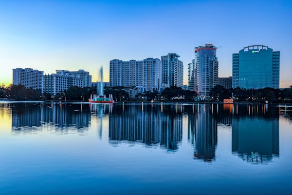 Downtown Orlando skyline reflected across Lake Eola at sunrise