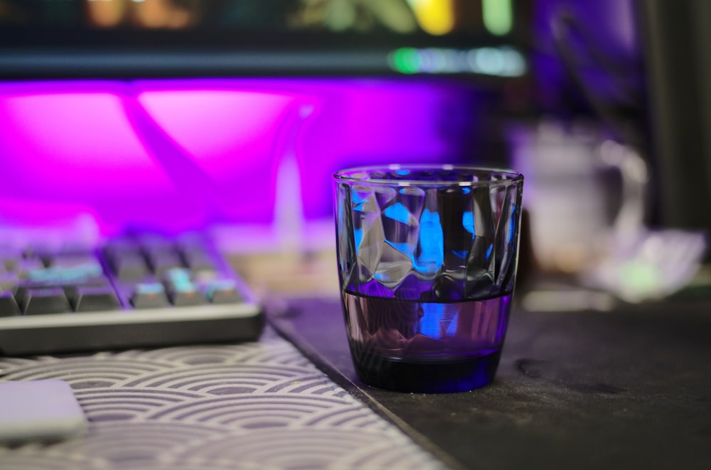 blue and black glass cup on table