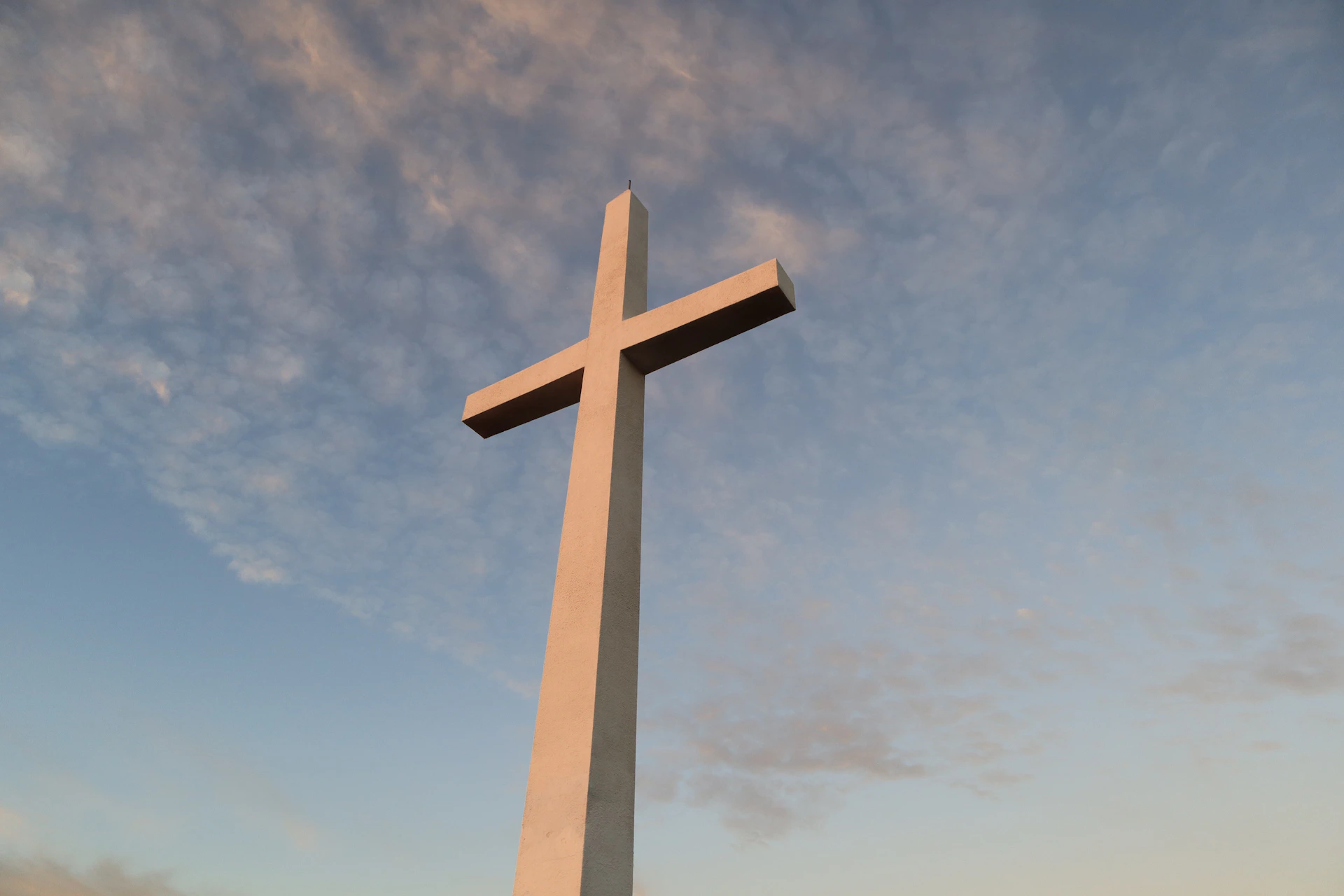 white cross under blue sky during daytime