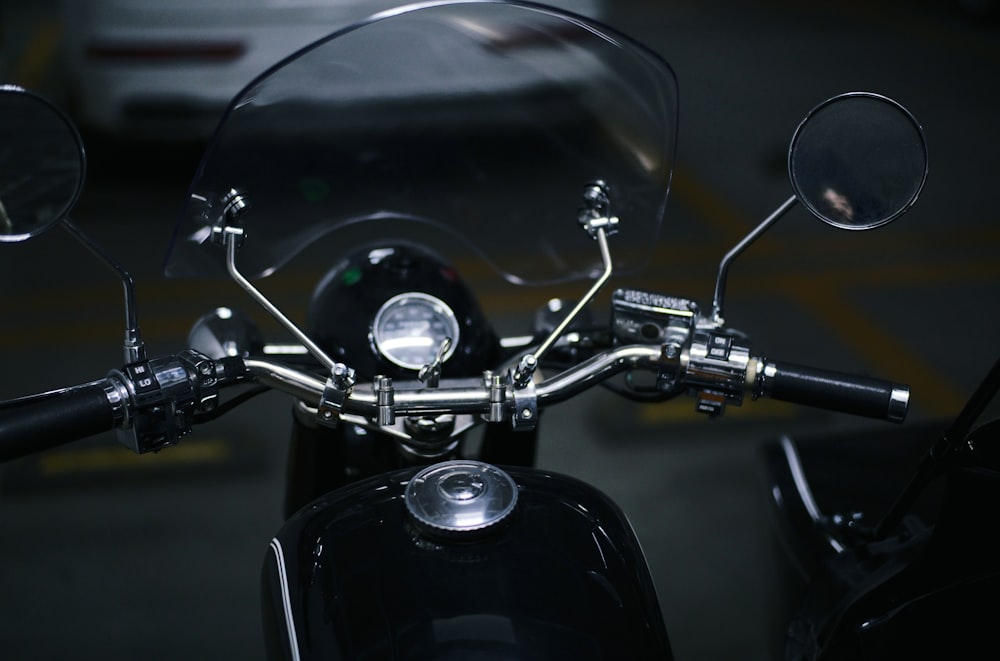 black motorcycle parked beside black car