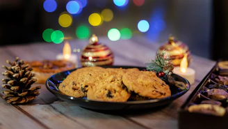 A warm, inviting photo of diverse hands sharing freshly baked cookies around a rustic wooden table.