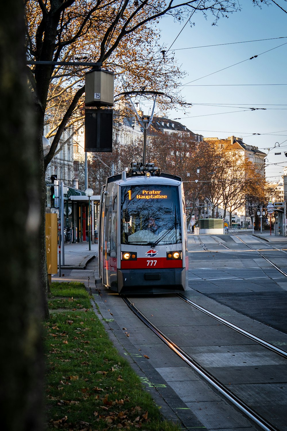 white and red tram on road during daytime