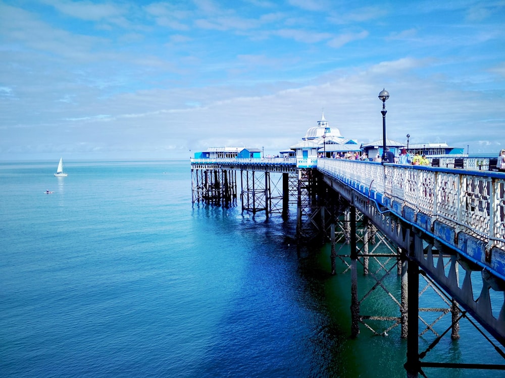 black wooden dock on blue sea under blue sky during daytime