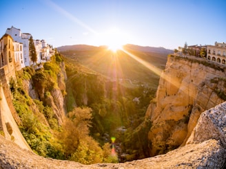 Scenic view of Alcalá del Júcar village with its cliffside houses and river at sunset.