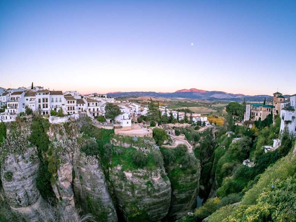 white concrete buildings on mountain during daytime