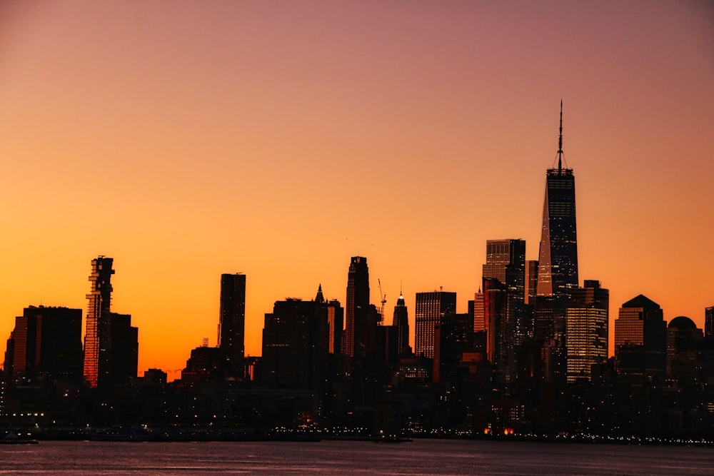 silhouette of city buildings during sunset