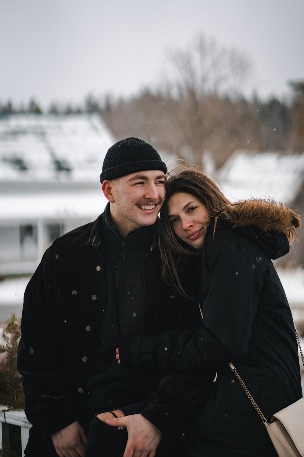 man and woman wearing black knit cap and black coat