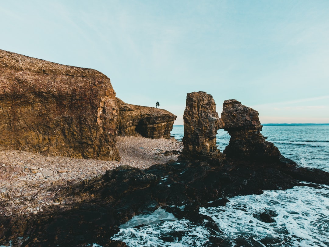 brown rock formation on sea during daytime