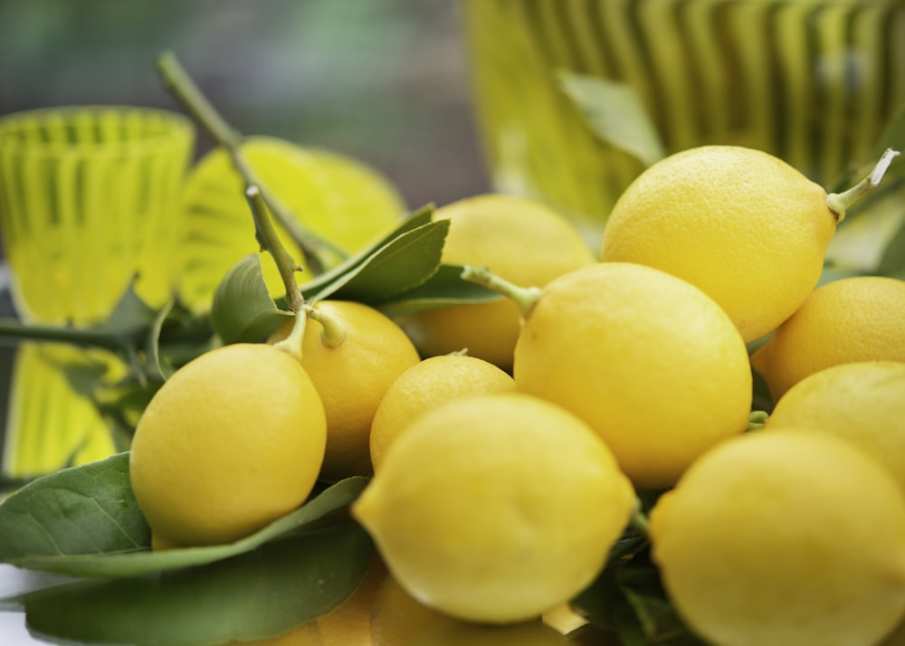 yellow citrus fruits on green leaves