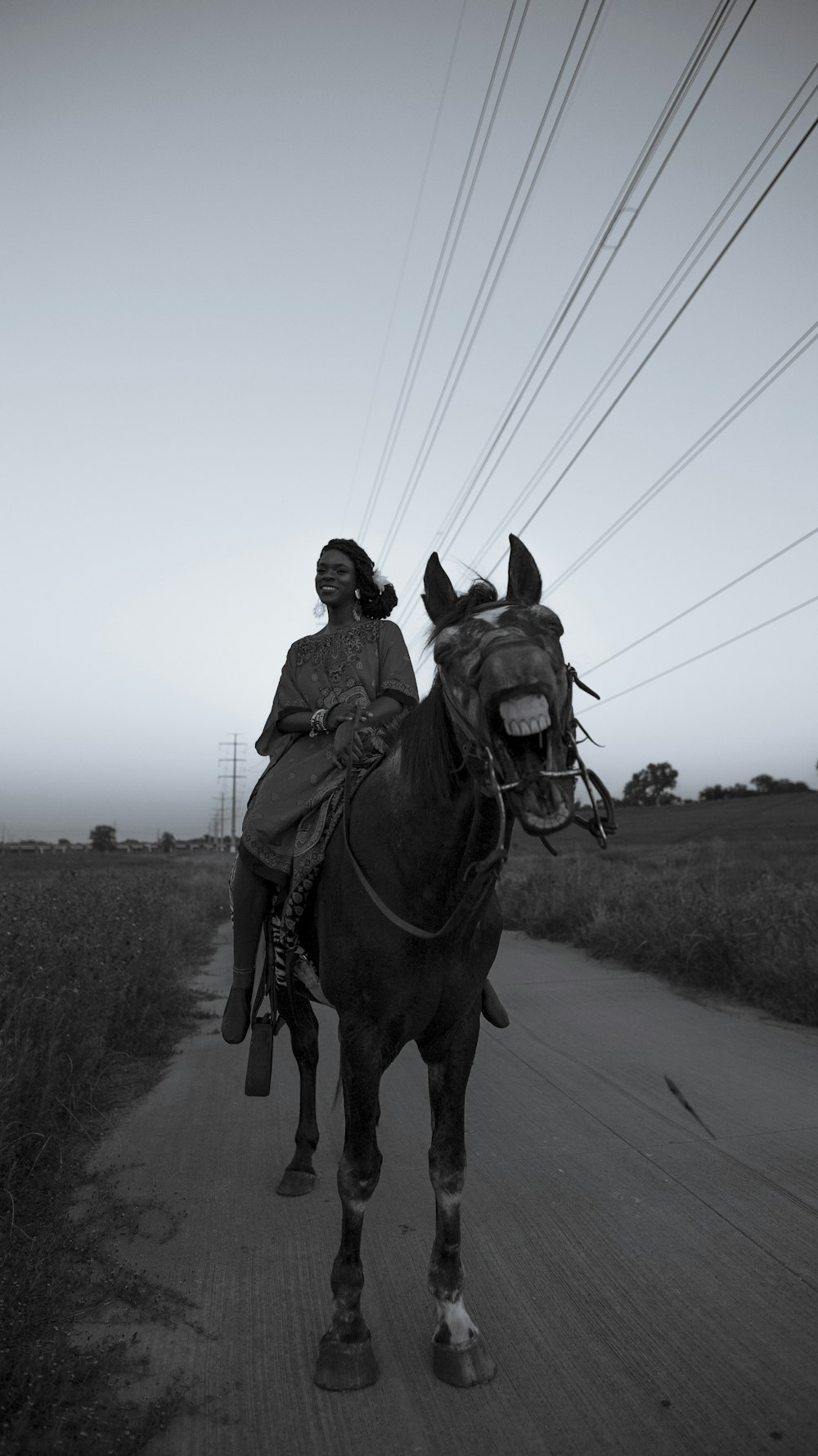 man riding horse on road during daytime