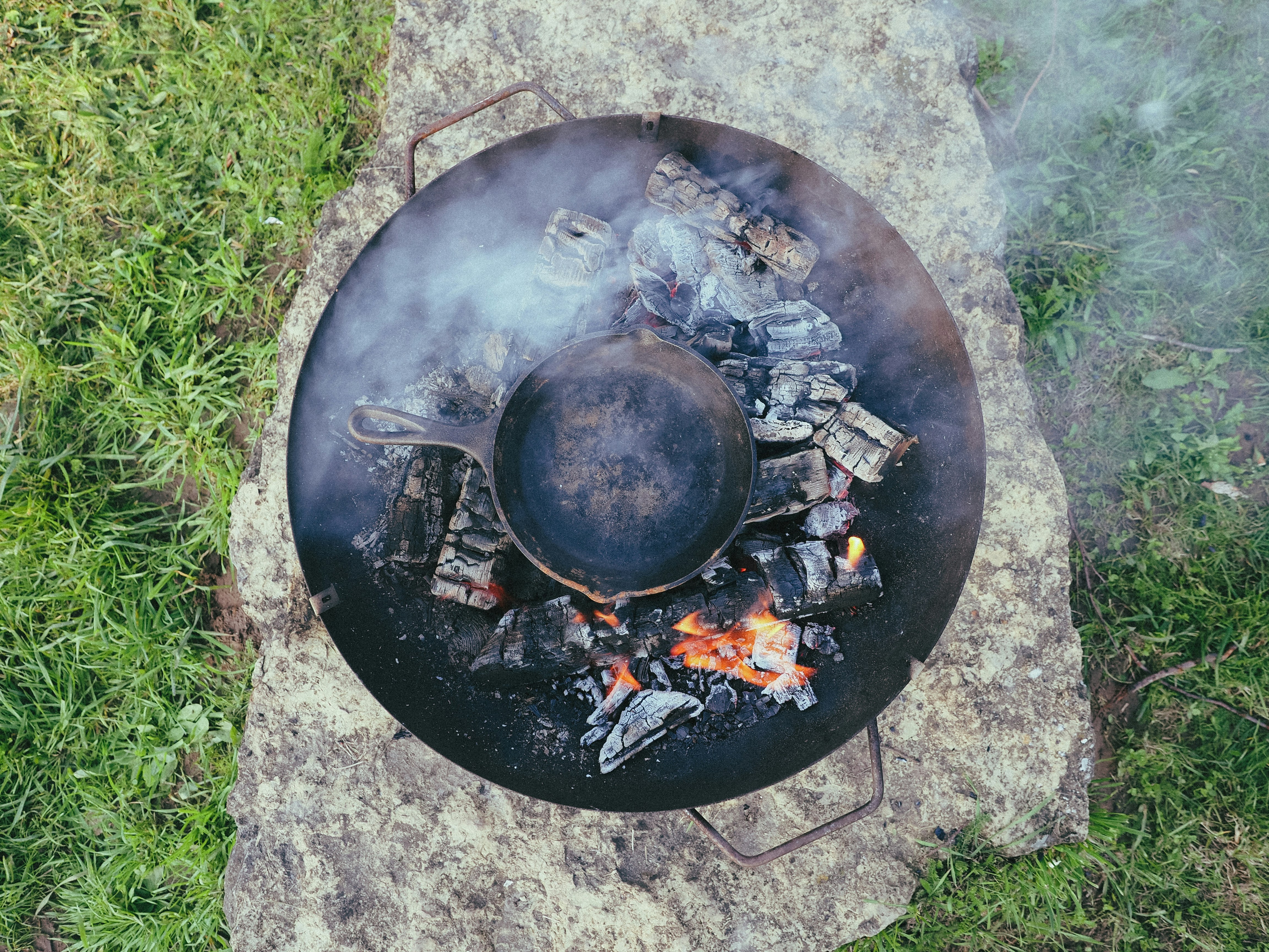 black round fire pit on green grass