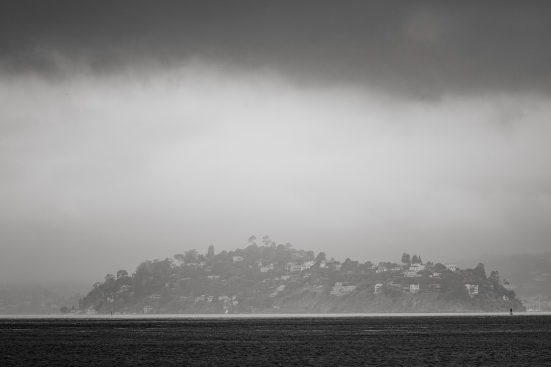 body of water under cloudy sky during daytime