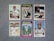 A collection of six vintage baseball cards featuring players from different teams, neatly arranged on a gray surface. Each card displays a portrait or action shot of a player, along with their team name and position.
