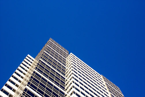 High-definition industrial office building exterior with clear blue sky backdrop.