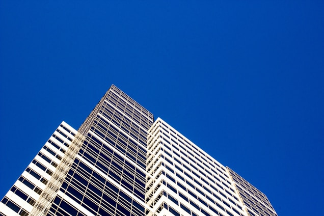 Modern commercial building with a clear blue sky background.