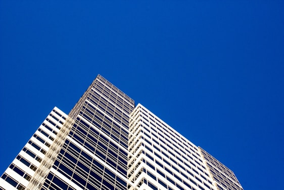 A modern commercial building with a clear blue sky in the background.