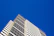 A commercial building with a sleek, freshly painted facade under a bright blue sky.
