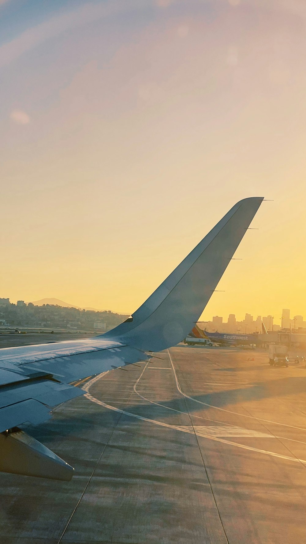 white airplane wing over city during daytime