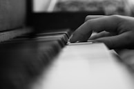 Close-up of hands on a piano keyboard, capturing the emotion of the music.