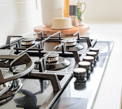 black and white chess pieces on black and silver gas stove