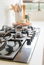 black and white chess pieces on black and silver gas stove