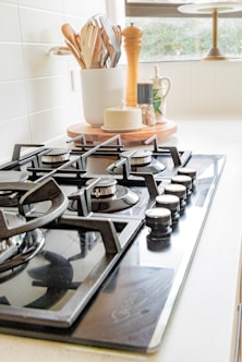 black and white chess pieces on black and silver gas stove