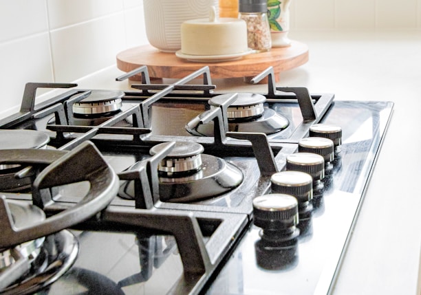 black and white chess pieces on black and silver gas stove