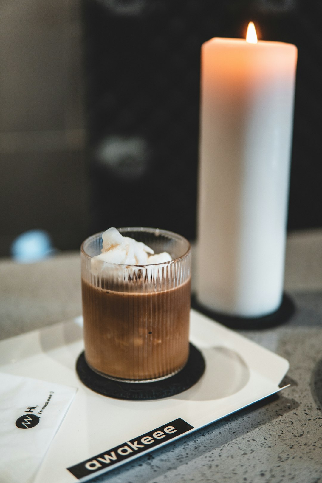 clear drinking glass with brown liquid on white ceramic plate