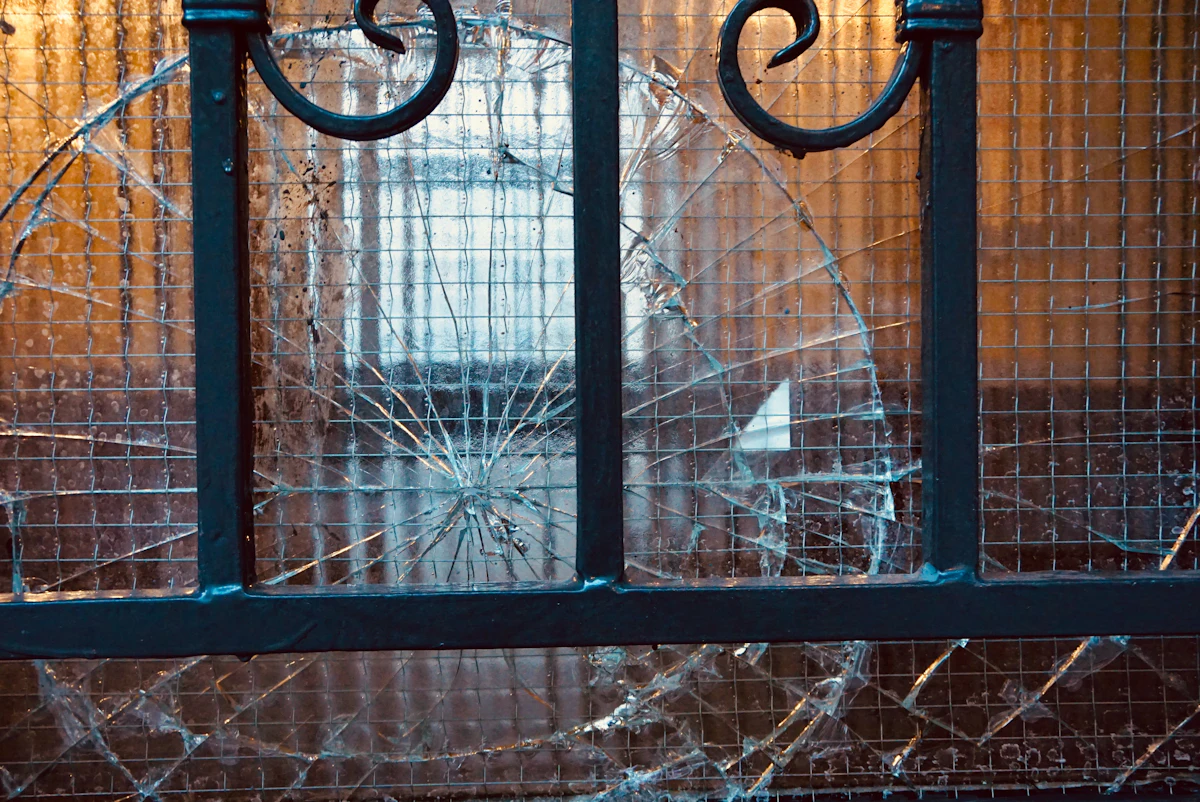 Cracked glass panel in a metal door frame