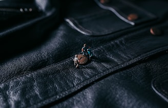 silver diamond ring on black leather textile