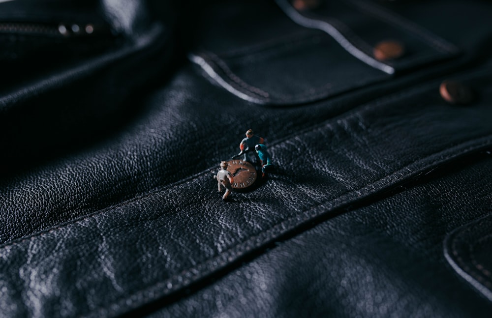 silver diamond ring on black leather textile