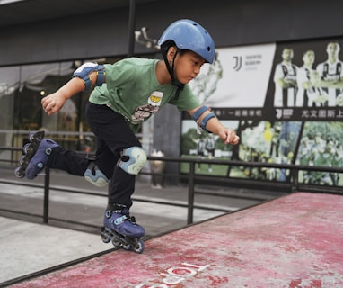 boy in green and white jersey shirt and blue helmet playing on red and black track