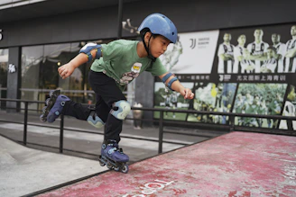 boy in green and white jersey shirt and blue helmet playing on red and black track